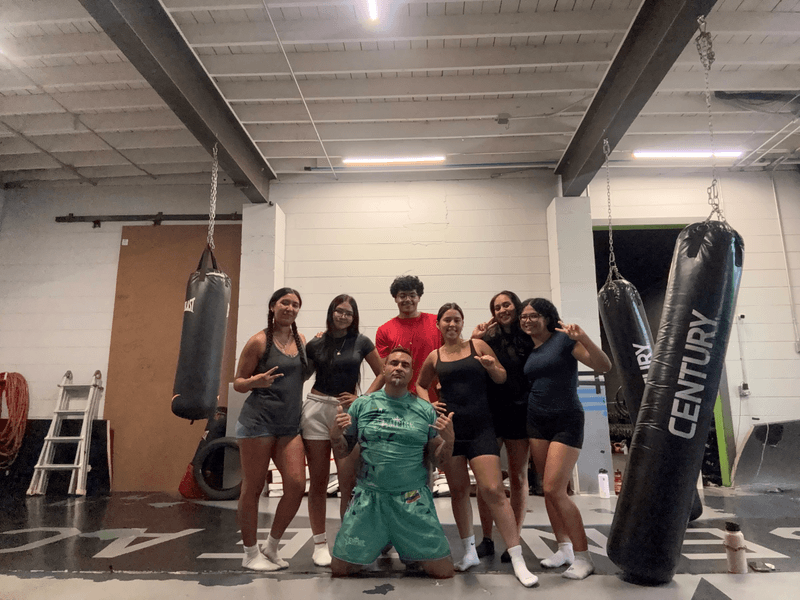 youth class group by the heavy bags at Empire MMA