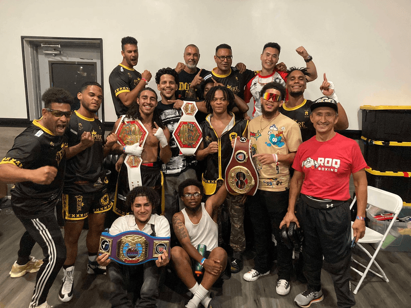 Empire MMA fight team posing with championship belts